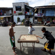 Youths play a form of pool on a carom board in Las Pinas city, Manila.